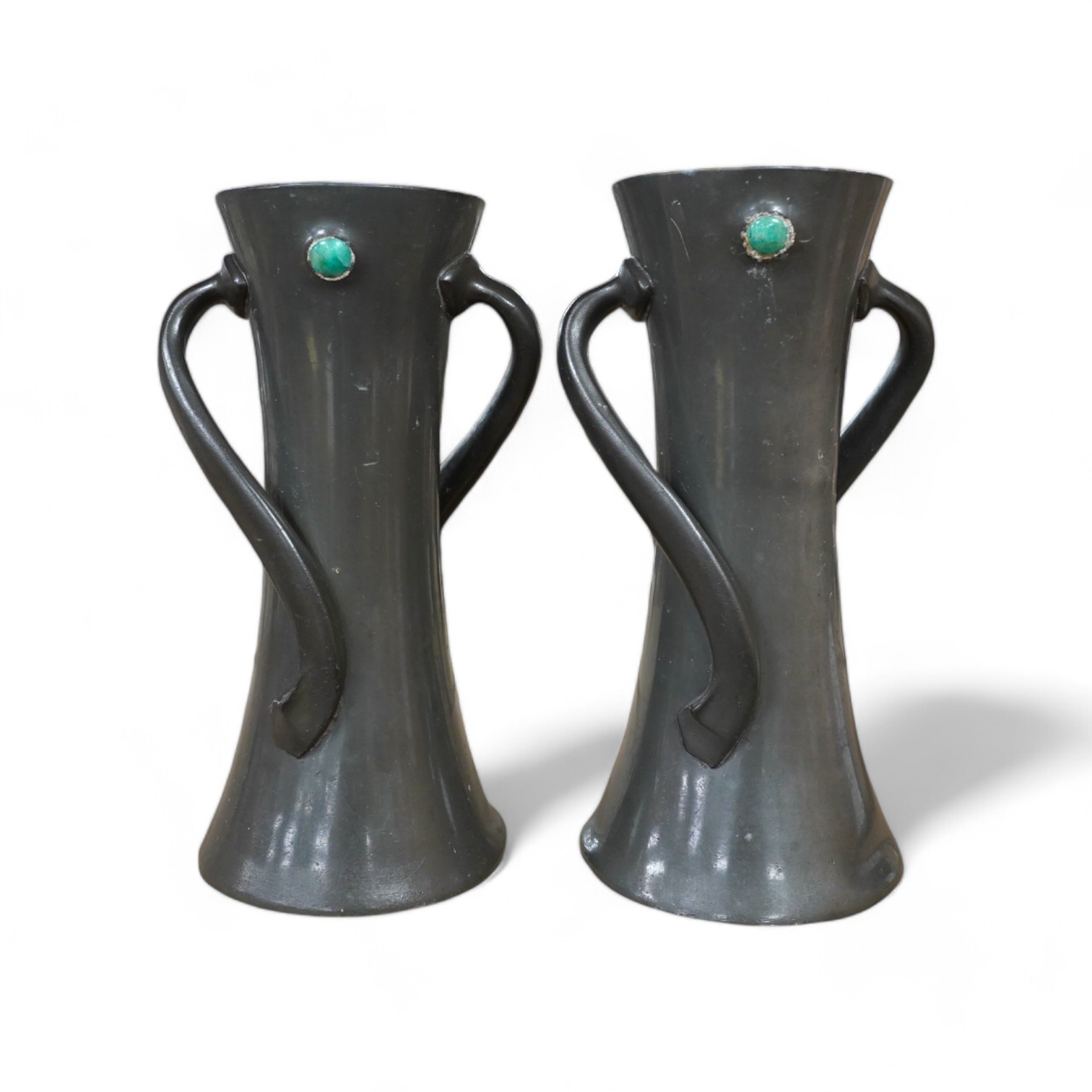 Two Liberty Tudric pewter vases with enamel cabochons, model no. 030, largest 19cm high. Condition - fair, one dented